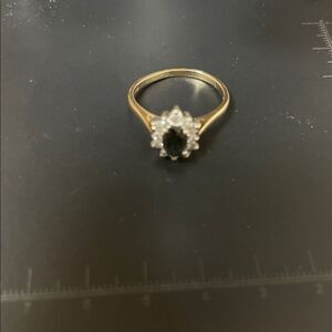 Vtg 14K P Gold Ring with Dk Blue Sapphire surrounded by 12 brilliant diamonds.